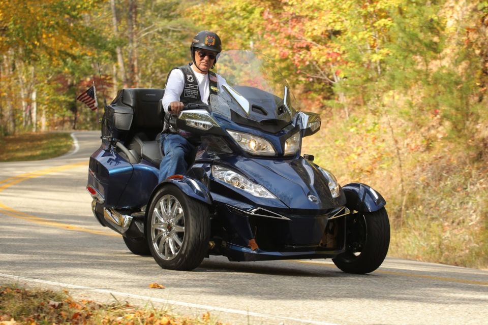 Blue three-wheeled Can-Am Spyder F3-S motorcycle with rider on a winding road
