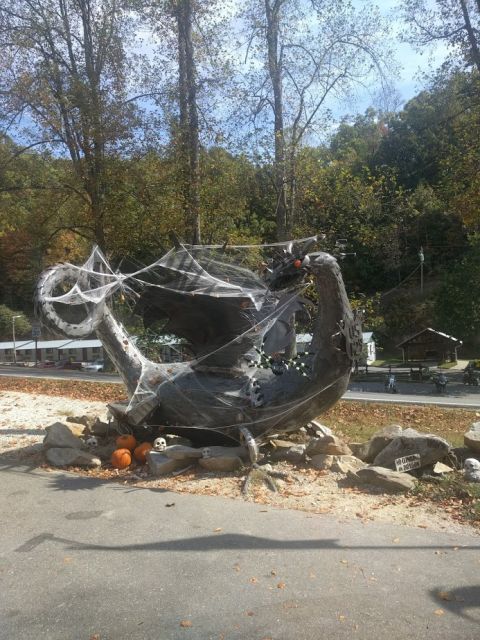 2014 Harley-Davidson FXDWGI Wide Glide - A Halloween dragon decoration sits outdoors, adorned with cobwebs and surrounded by pumpkins and skulls.