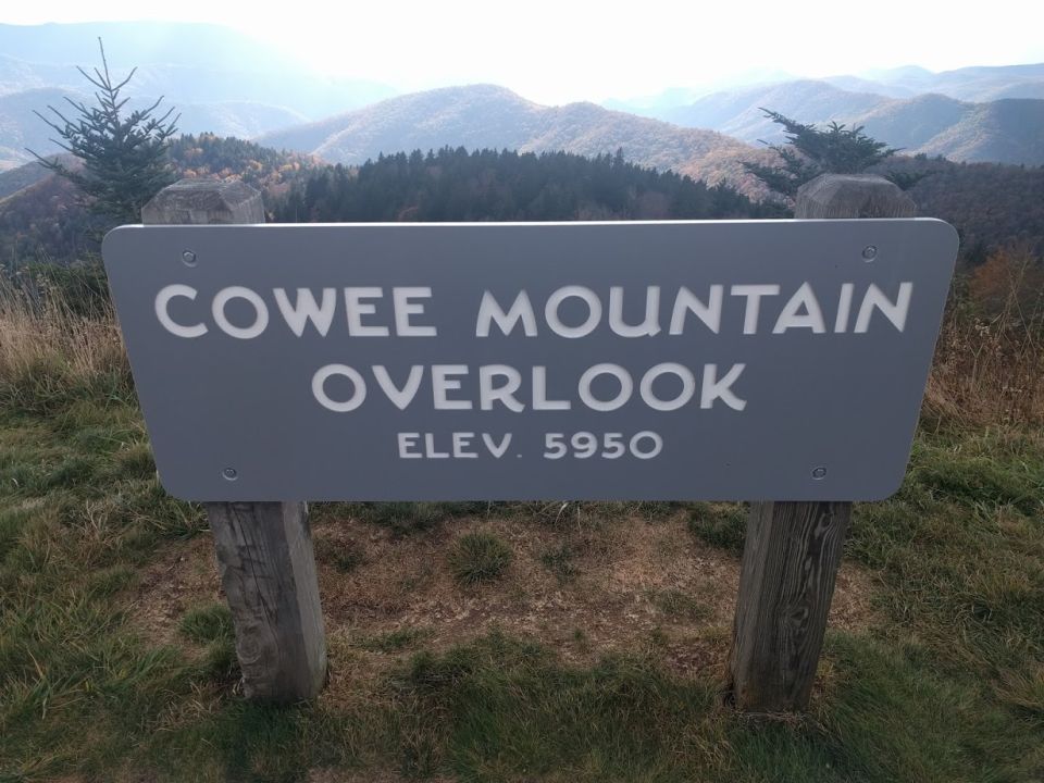 Sign for Cowee Mountain Overlook, elevation 5950, with mountains in the background