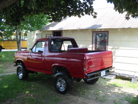 1981 Ford Bronco - This red Ford Bronco has a removable top and aftermarket wheels.