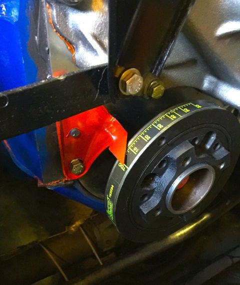 1978 Ford Bronco - A close-up view of a vehicle's crankshaft pulley with timing marks and a belt. The pulley is black with yellow and white markings, and a bl…