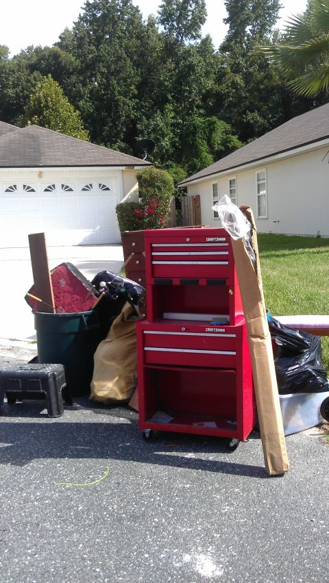 1994 Ford Bronco - A red Craftsman toolbox sits on a driveway next to a green trash can filled with various items, including a red shovel and a black grill. O…
