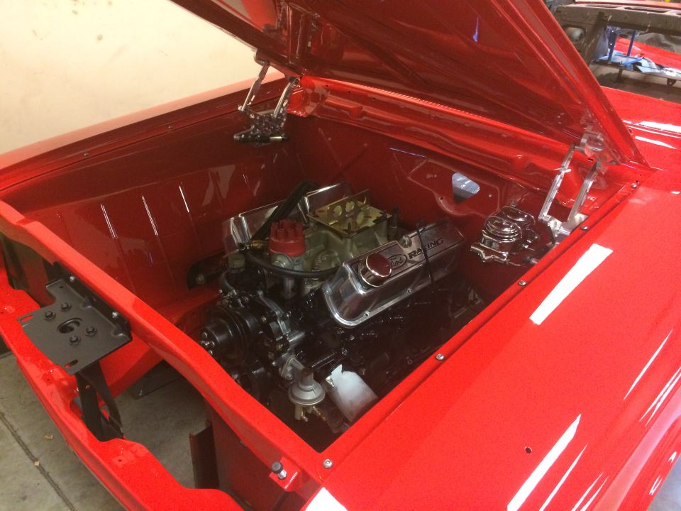 Red 1964 Ford Fairlane engine bay with V8 engine and Ford Racing valve cover.