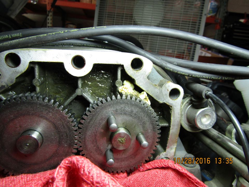 Close-up of engine gears and grease, with visible text on a cable.