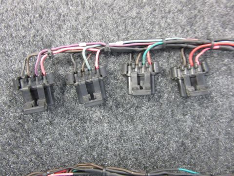Wiring harness with black connectors and multi-colored wires.