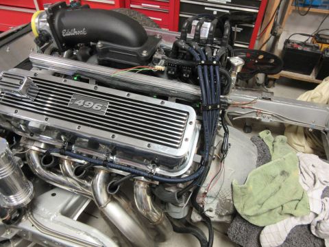 Chrome engine with "496" on valve cover, black spark plug wires, Edelbrock intake.