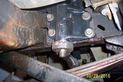 1973 Ford F-250 - Close-up view of the steering box mounting bolts and a cracked frame rail on a vehicle. The area is covered in grease and grime.