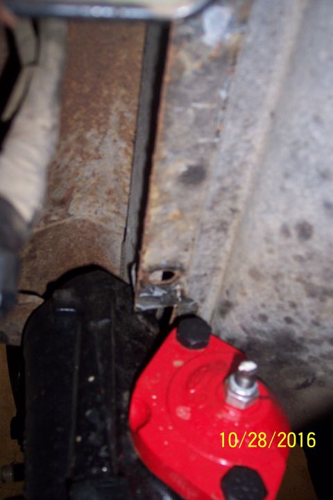 1973 Ford F-250 - A close-up view shows a red aftermarket part, possibly a suspension component, bolted to a black vehicle part. The date "10/28/2016" is vis…