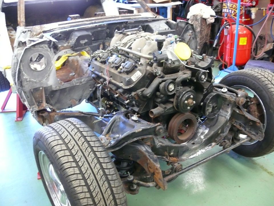 Engine and front chassis of a classic car project, with suspension and tire.