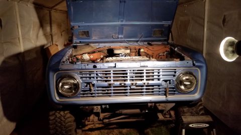 1973 Ford Bronco - Close-up of a car's dashboard, showing the radio and instrument cluster.
