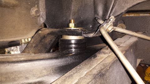 1976 Ford Ranchero - Close-up of a vehicle's frame mount, showing a rubber isolator and bolt assembly.
