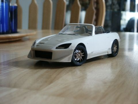 1998 Mercury Sable - Model car with custom wheels sits on a wood-grain surface.