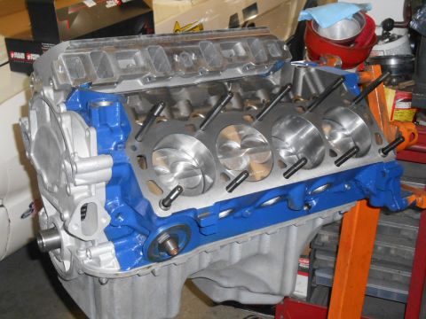 1972 Ford Bronco - A V8 engine block is shown with its internal components partially visible, painted in blue and silver.