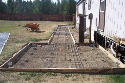 1989 Ford Bronco - Forms and rebar are laid out for a concrete patio extension next to a mobile home.