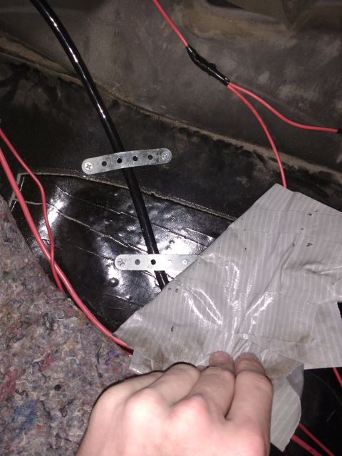 1996 Ford Bronco - Main power cord strapped down under passenger carpet.