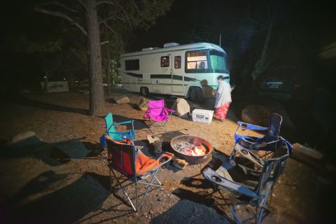 1995 Chevrolet P30 1 Ton - Step Van - A 1995 Chevrolet P30 step van, nicknamed "Flair 22D", is parked at a campsite at night. The RV is illuminated by interior lights and a camp…
