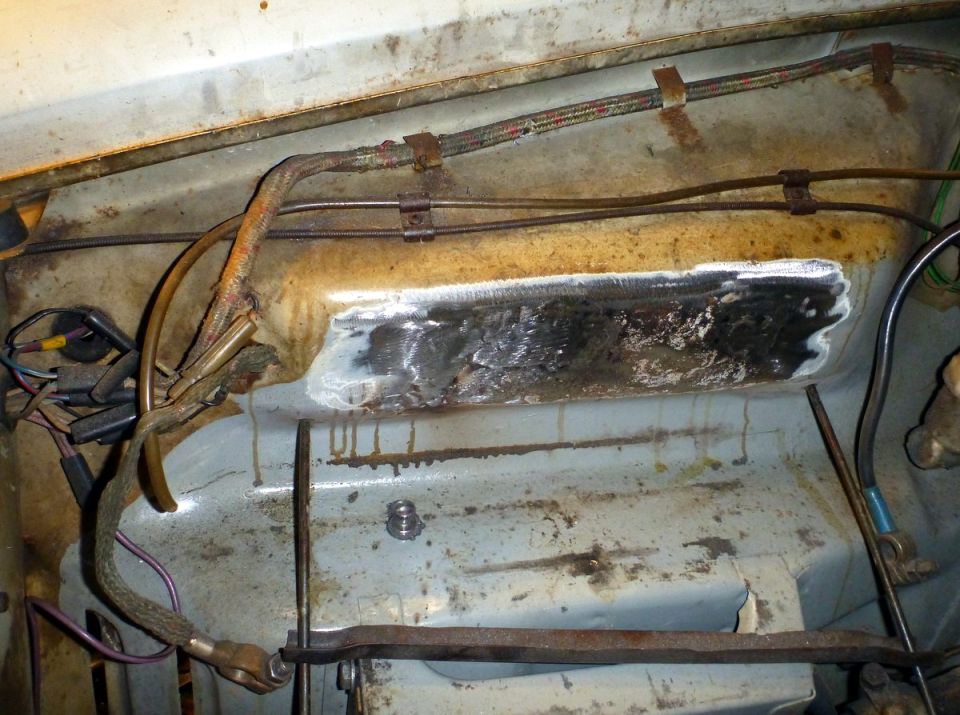 Welded patch on engine bay component with wiring and hoses