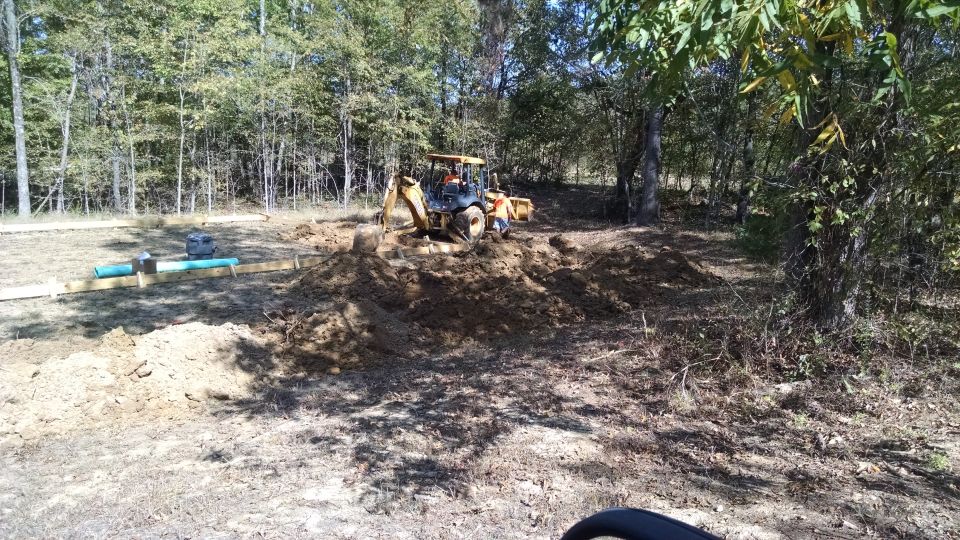 The plumber started tearing up the pad, bringing in water from the well, and running a septic line back to the house.