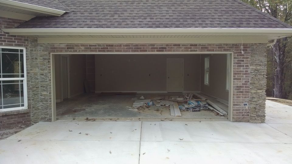 Exterior of a house under construction with an open garage.