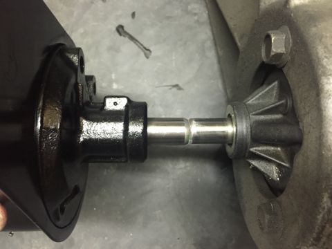 1988 Ford Bronco - A close-up view shows a metal shaft connecting a black component on the left to a gray, finned component on the right, likely part of a veh…