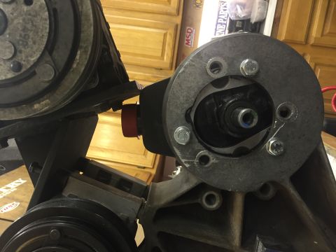 1988 Ford Bronco - A close-up view shows a power steering pump assembly mounted to an engine block. The assembly features a pulley and is secured with multipl…