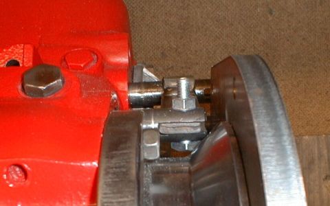 1990 Ford Bronco - Detail of a mechanical component, possibly from a vehicle's drivetrain, with visible bolts and metalwork.