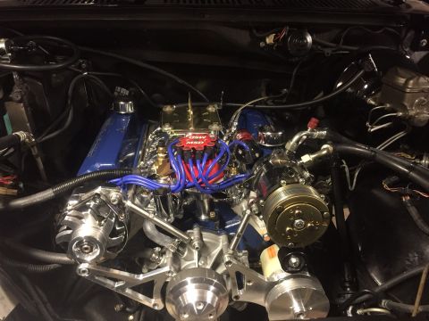 1982 Ford Bronco - A highly polished engine bay with a blue intake manifold and chrome accessories is shown in a vehicle. Visible components include MSD spark…
