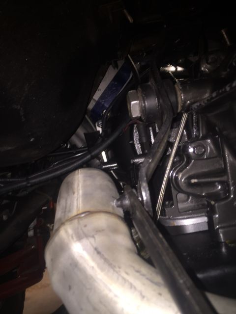 1982 Ford Bronco - A close-up view of the underside of a vehicle, focusing on the exhaust pipe and suspension components. The image shows metallic exhaust pip…