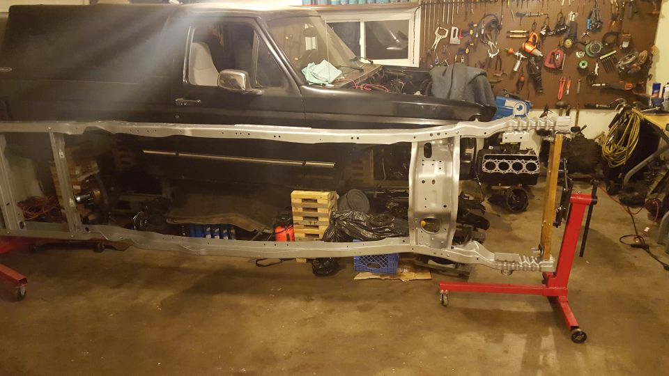1994 Ford Bronco body lifted off frame, engine on stand, tools in garage