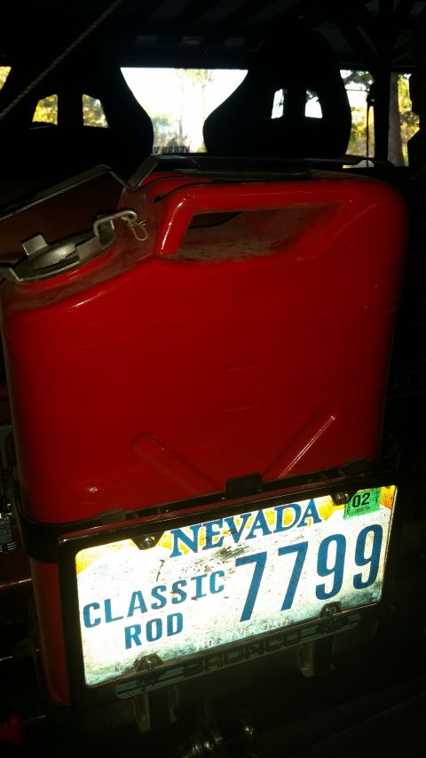 1979 Ford Bronco - A red jerry can is mounted on the back of a vehicle, with a Nevada license plate reading "CLASSIC ROD 7799" attached below it.