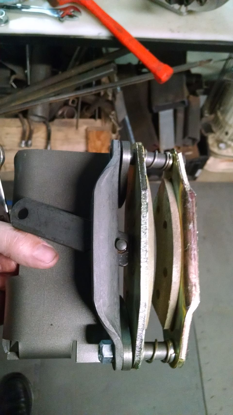 Close-up of a brake caliper assembly with new brake pads installed.