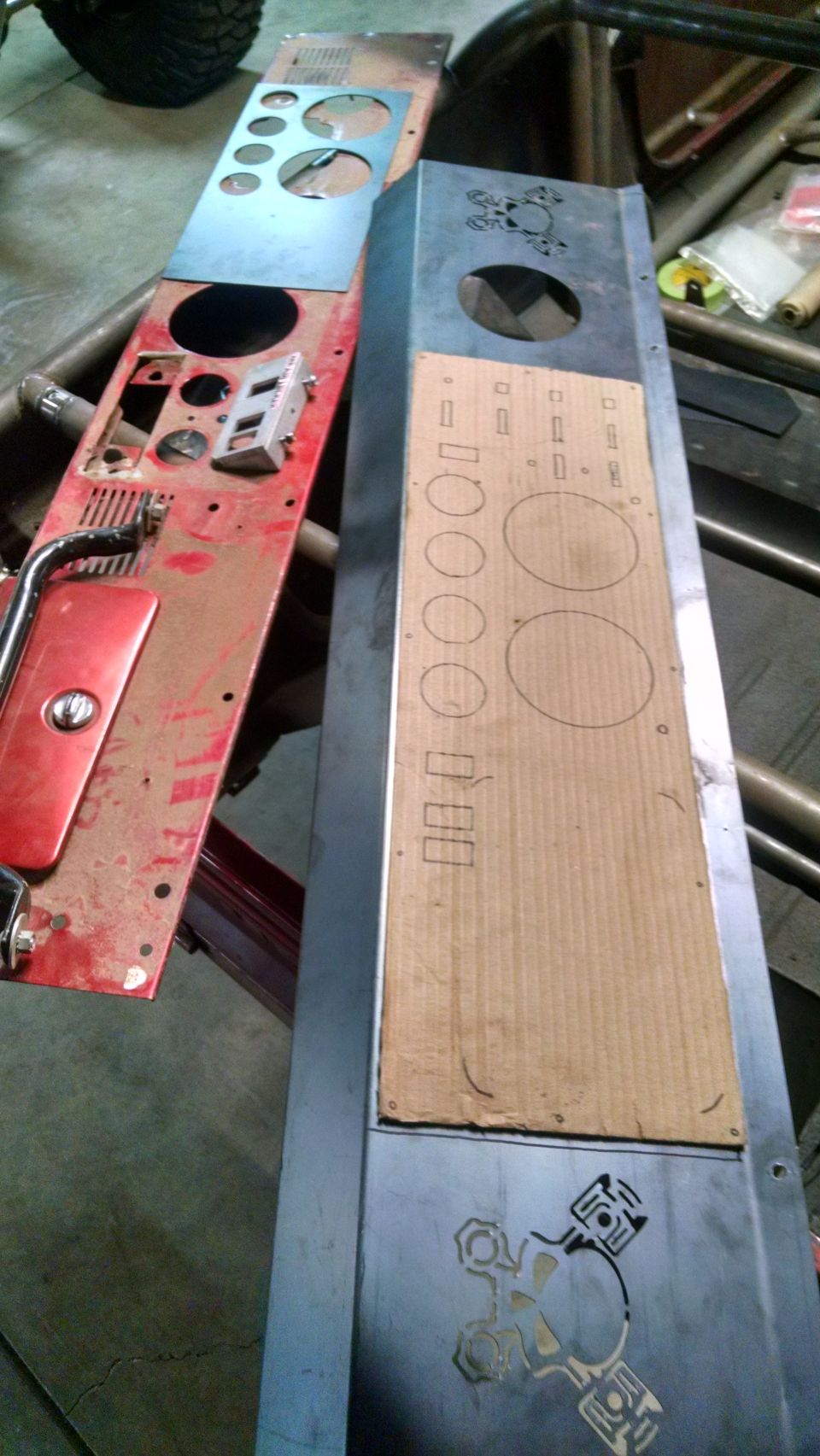 Two dashboard panels, one red with gauge cutouts, one metal with cardboard template