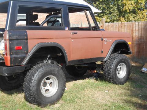 1972 Ford Bronco - A modified Ford Bronco with a lifted suspension and off-road tires sits on a grassy lawn.