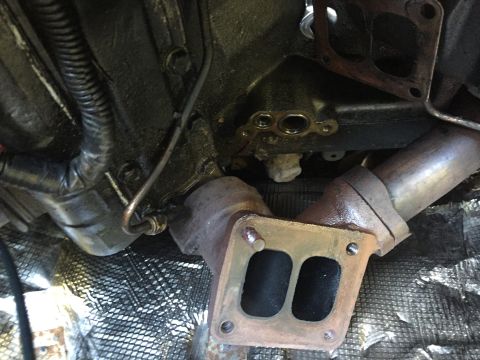 1997 Ford F-350 - Close-up view of engine exhaust manifold and associated piping, with visible wiring and engine block components.