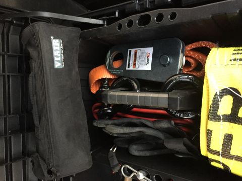 1988 Ford Bronco - Storage compartment filled with various vehicle recovery and air supply equipment.