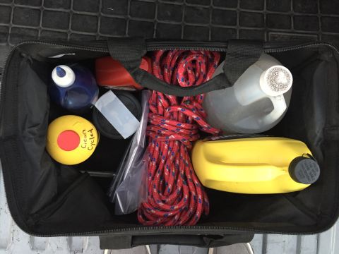 1988 Ford Bronco - A black storage bag contains various items including rope, bottles, and a yellow ball.