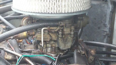 1984 Ford Bronco - Close-up view of an engine's carburetor and air filter assembly.