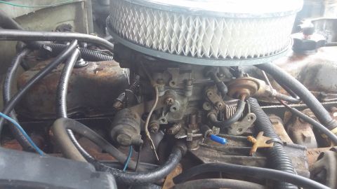 1984 Ford Bronco - Close-up view of an engine's carburetor and air filter assembly.