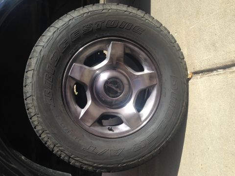 2001 Ford Ranger - Spare tire and wheel assembly, likely for a truck or SUV, with Bridgestone Dueler A/T tires.