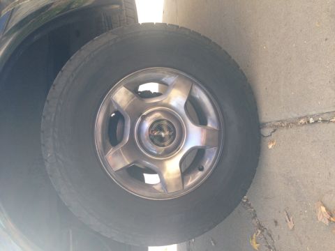 2001 Ford Ranger - A close-up view of a vehicle's wheel and tire, a center cap with "Limited" text.