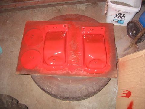 1985 Ford Bronco - Painted metal parts and circular plates are laid out on a tire.