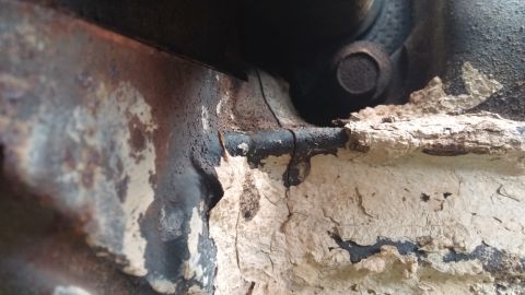 1984 Ford Bronco - Engine block detail with significant paint deterioration and corrosion.