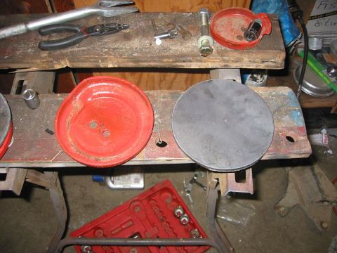 1985 Ford Bronco - Automotive parts and tools are laid out on a workbench, possibly for a repair or modification.