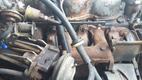 1984 Ford Bronco - Engine compartment details showing various parts and connections.