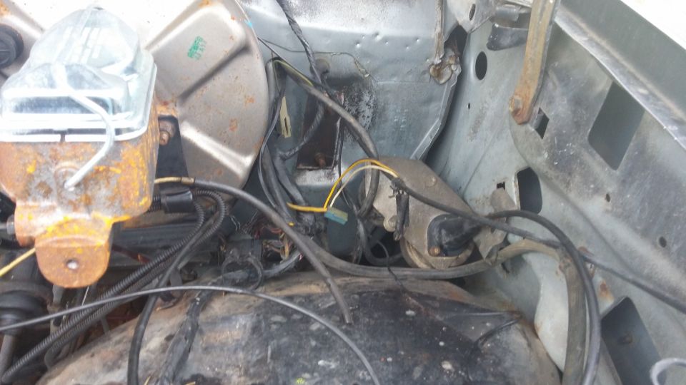 Engine bay showing brake master cylinder and wiring harness