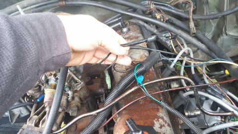 1984 Ford Bronco - Close-up view of a vehicle's engine bay, focusing on wiring and electrical connections.