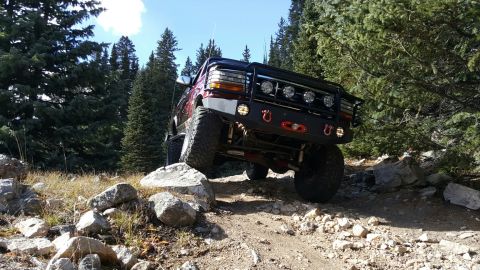 1996 Ford Bronco - This 1996 Ford Bronco is navigating a challenging rocky terrain on an off-road trail.