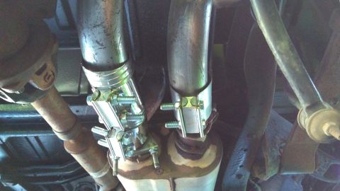 1996 Ford Bronco - Here's my redneck install for the second pipe; ugly but it works. I have another coupler u-bolted to the muffler, then a flex pipe running…