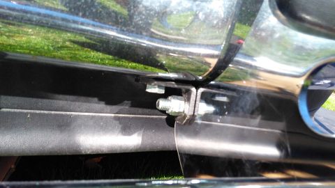 1996 Ford Bronco - Detail of a chrome push bar mounting bracket, showing hardware and attachment points.