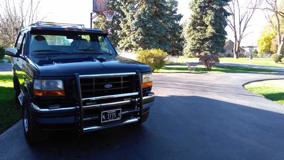 Black 1996 Ford Bronco with push bar and roof rack